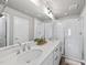 Modern bathroom with double vanity, sleek white countertops, and glass-enclosed shower at 1641 Glazebrook Dr, Wake Forest, NC 27587