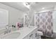 Bathroom featuring double sinks, white countertops, and a shower with a decorative curtain at 1641 Glazebrook Dr, Wake Forest, NC 27587