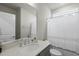 Clean bathroom features a large mirror, updated vanity, white shower curtain, and natural light at 1641 Glazebrook Dr, Wake Forest, NC 27587