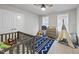 Cozy bedroom featuring a ceiling fan, a crib, and natural light from two windows at 1641 Glazebrook Dr, Wake Forest, NC 27587