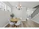Bright dining area features modern lighting, neutral walls, and hardwood flooring at 1641 Glazebrook Dr, Wake Forest, NC 27587