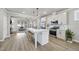 Bright, open kitchen featuring a center island with seating, stainless steel appliances, and hardwood floors at 1641 Glazebrook Dr, Wake Forest, NC 27587