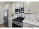 Close-up of kitchen featuring stainless steel appliances, white cabinets, and sleek countertops at 1641 Glazebrook Dr, Wake Forest, NC 27587