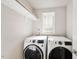 Well-lit laundry room with modern, side-by-side washer and dryer units at 1641 Glazebrook Dr, Wake Forest, NC 27587