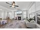 Well-lit living room with a fireplace, large windows, and an open layout to dining area at 1641 Glazebrook Dr, Wake Forest, NC 27587