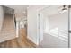 View of a staircase and open living space with hardwood floors flowing into the connected kitchen and living room at 1641 Glazebrook Dr, Wake Forest, NC 27587
