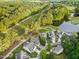 An aerial view of the community and golf course with lush trees and a tranquil lake at 17 Nicklaus Way, Clayton, NC 27520