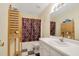 Bathroom featuring a single vanity, patterned shower curtain, and checkered floor at 17 Nicklaus Way, Clayton, NC 27520