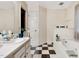 Bathroom with a bathtub, shower, and black and white checkered flooring at 17 Nicklaus Way, Clayton, NC 27520
