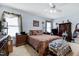 Spacious bedroom with two windows, ceiling fan, and carpeted floor at 17 Nicklaus Way, Clayton, NC 27520