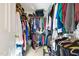 Walk-in closet well-organized with clothing on hangers and shelves at 17 Nicklaus Way, Clayton, NC 27520