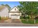 Charming home featuring a two-car garage, landscaped front yard, and mature trees at 17 Nicklaus Way, Clayton, NC 27520