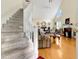 Bright living room with hardwood floors, fireplace, vaulted ceiling, and staircase at 17 Nicklaus Way, Clayton, NC 27520