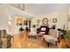 Cozy living room featuring hardwood floors, neutral paint, and access to additional spaces at 17 Nicklaus Way, Clayton, NC 27520