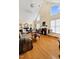 Sunlit living room with hardwood floors, fireplace, and vaulted ceilings at 17 Nicklaus Way, Clayton, NC 27520