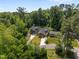 Aerial view showcasing the home's setting amidst lush trees and proximity to neighboring houses at 2003 Wa Wa Ave, Durham, NC 27707