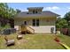 Backyard with a small deck and grassy area, perfect for relaxation and entertainment at 2003 Wa Wa Ave, Durham, NC 27707