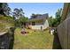 Backyard featuring a grassy area, a small deck, and an enclosed space at 2003 Wa Wa Ave, Durham, NC 27707