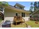 Exterior view of home's backyard, featuring a small deck and grassy area at 2003 Wa Wa Ave, Durham, NC 27707