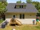 Home backyard featuring a wood deck, lawn, new roof, and beige siding at 2003 Wa Wa Ave, Durham, NC 27707