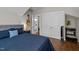 Bedroom with hardwood floors, closet, guitar on wall, and en-suite bathroom entrance at 2003 Wa Wa Ave, Durham, NC 27707