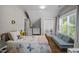 Cozy room with wood floors, rug, and light blue play couch at 2003 Wa Wa Ave, Durham, NC 27707