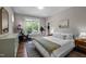 Inviting bedroom with large windows, hardwood floors, and an exercise bike for a healthy lifestyle at 2003 Wa Wa Ave, Durham, NC 27707