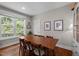 Bright dining room with large window, wood table, and chairs, perfect for gatherings and Gathering meals at 2003 Wa Wa Ave, Durham, NC 27707