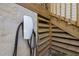 Close-up view of an installed Tesla electric vehicle charger located near the wooden stairs at 2003 Wa Wa Ave, Durham, NC 27707