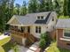Charming home featuring a welcoming porch, complemented by well-maintained landscaping and an electric vehicle charger at 2003 Wa Wa Ave, Durham, NC 27707