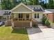 Charming bungalow with a covered front porch, wooden deck, and well-maintained lawn at 2003 Wa Wa Ave, Durham, NC 27707