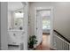 Hallway leading to a bright bathroom with a large vanity, and an airy, sunlit room at 2003 Wa Wa Ave, Durham, NC 27707