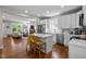Bright kitchen featuring white cabinets, stainless steel appliances, and an island that opens to the living area at 2003 Wa Wa Ave, Durham, NC 27707