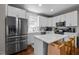 Modern kitchen with stainless steel appliances, white cabinets, and center island at 2003 Wa Wa Ave, Durham, NC 27707