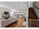 Spacious living room with hardwood floors, a staircase, and an open view to the kitchen at 2003 Wa Wa Ave, Durham, NC 27707