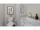Stylish half bathroom features marble countertops, modern fixtures, and a decorative mirror at 2003 Wa Wa Ave, Durham, NC 27707