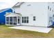 Exterior view of a white home featuring a screened in porch and concrete patio at 2014 Anna Lilley Dr, Fuquay Varina, NC 27526