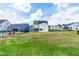 Large backyard with a white house featuring a screened-in porch and a blue house next door at 2014 Anna Lilley Dr, Fuquay Varina, NC 27526