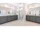 Elegant bathroom featuring double vanity, quartz countertop, and a glass enclosed walk-in shower at 2014 Anna Lilley Dr, Fuquay Varina, NC 27526