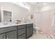 Charming bathroom featuring double vanity, colorful shower curtain, and a rainbow-themed decor at 2014 Anna Lilley Dr, Fuquay Varina, NC 27526