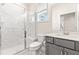 Modern bathroom featuring a glass-enclosed shower, vanity, and ample lighting at 2014 Anna Lilley Dr, Fuquay Varina, NC 27526