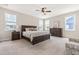Bedroom with a dark wood bed, matching dressers, and neutral decor, creating a cozy atmosphere at 2014 Anna Lilley Dr, Fuquay Varina, NC 27526