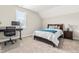 Cozy bedroom with neutral walls features a large window, bed, and a dedicated workspace at 2014 Anna Lilley Dr, Fuquay Varina, NC 27526
