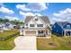 Beautiful two-story home with a white exterior, brown shutters, and a well-manicured lawn in a friendly neighborhood at 2014 Anna Lilley Dr, Fuquay Varina, NC 27526