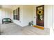 Cozy front porch with a decorative wreath on the front door and a welcome mat at 2014 Anna Lilley Dr, Fuquay Varina, NC 27526