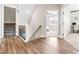Hallway with wooden floors, white trim, staircase with iron spindles, and bedroom access at 2014 Anna Lilley Dr, Fuquay Varina, NC 27526
