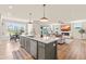 Open kitchen with a large center island, barstool seating, and views of the dining and living areas at 2014 Anna Lilley Dr, Fuquay Varina, NC 27526