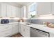 Bright kitchen featuring white cabinets, stainless steel appliances, and stylish backsplash, blending style and functionality at 2014 Anna Lilley Dr, Fuquay Varina, NC 27526
