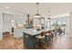 Modern kitchen featuring a large center island, pendant lighting, stainless steel appliances and a dining area at 2014 Anna Lilley Dr, Fuquay Varina, NC 27526
