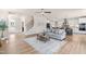 Inviting living room with hardwood floors, a ceiling fan, fireplace, and access to the staircase at 2014 Anna Lilley Dr, Fuquay Varina, NC 27526